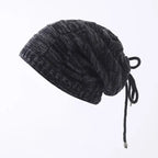 Dark gray knit beanie with drawstring on a white background