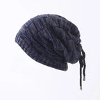 Knitted beanie with drawstring on a white background