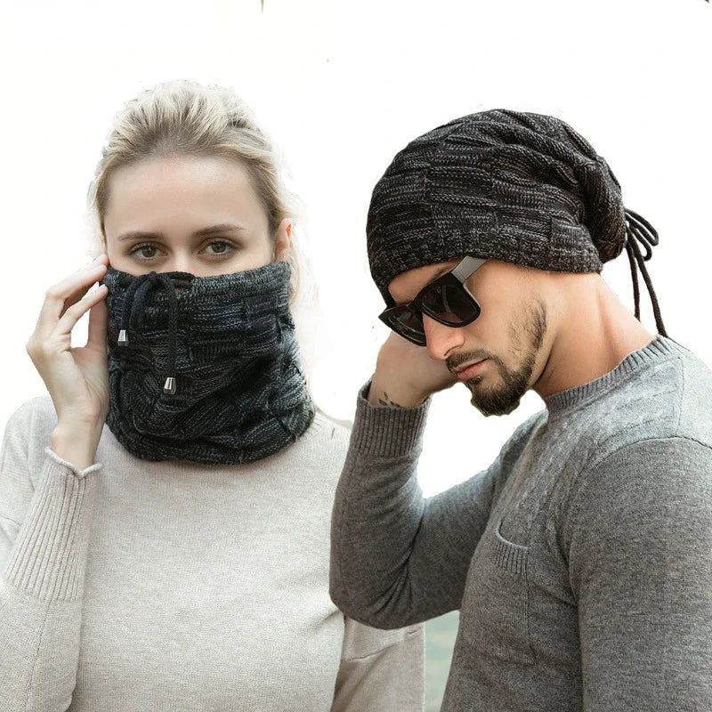 Two people wearing black knit face masks and hats on a white background