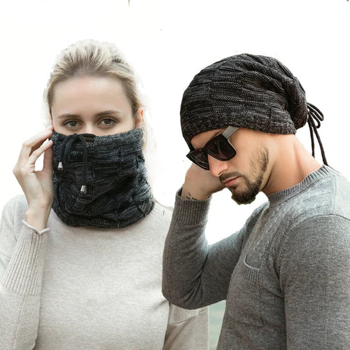 Two people wearing black knit face masks and hats on a white background