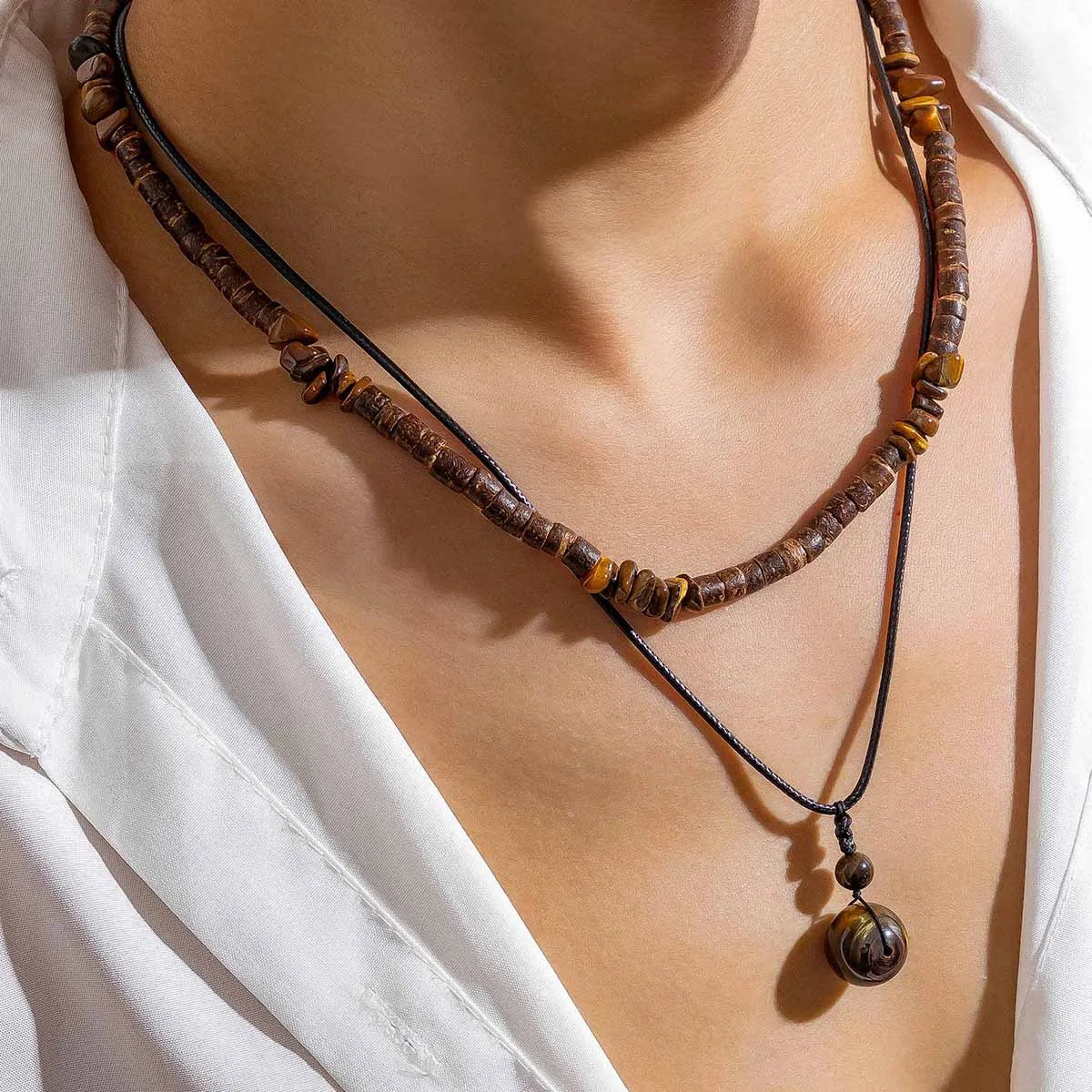 Necklace with brown beads on a white shirt