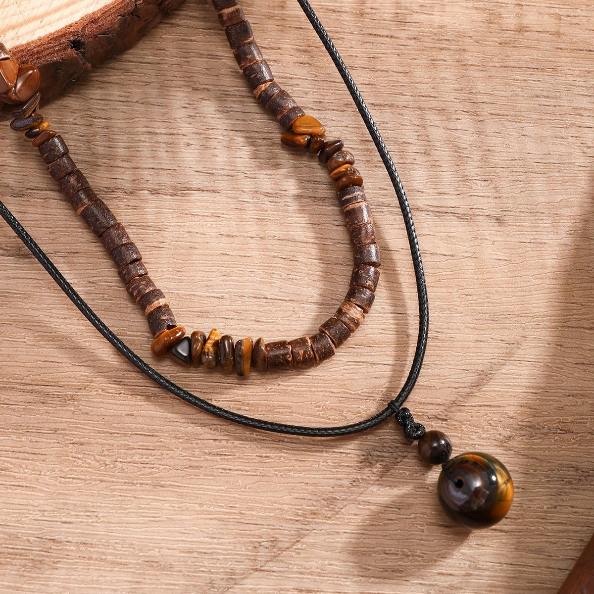Beaded necklace with brown and black beads on a wooden surface