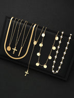 Set of gold necklaces with various designs on a black background