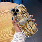 Phone case with unicorn design held by a hand on a wooden surface