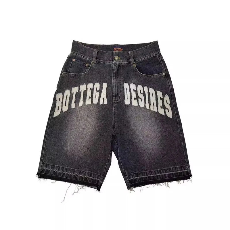 Black denim shorts with 'Bottega Desires' text on a white background