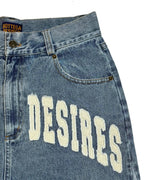Blue vintage denim jeans with 'DESIRES' text and Bottega Veneta label.