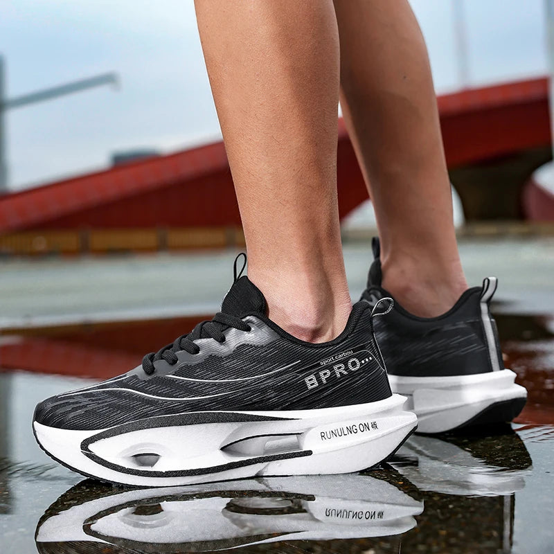 Black and white running shoes with visible branding on a reflective surface.