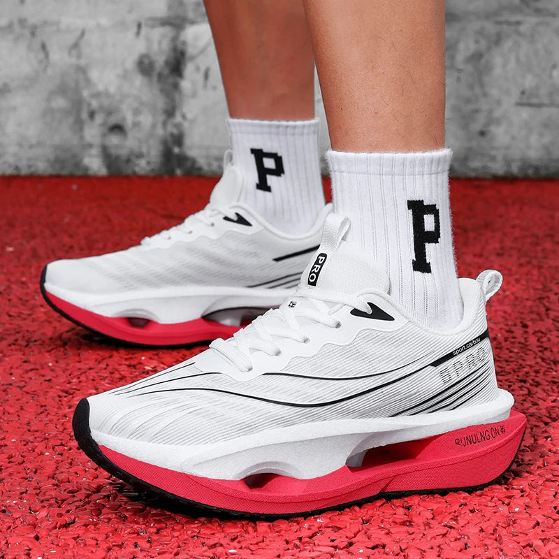 White sneakers with red soles worn on a red surface