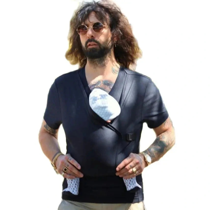 Man wearing a black leather vest over a graphic t-shirt with a white design.