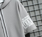 Gray hoodie with a brand logo on a grid background