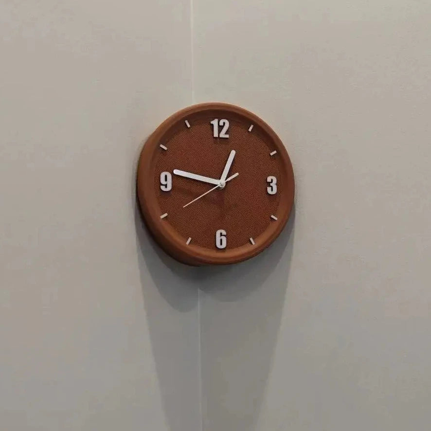 A round wall clock with a warm brown wood-grain finish and white hands, mounted on a light gray corner wall.