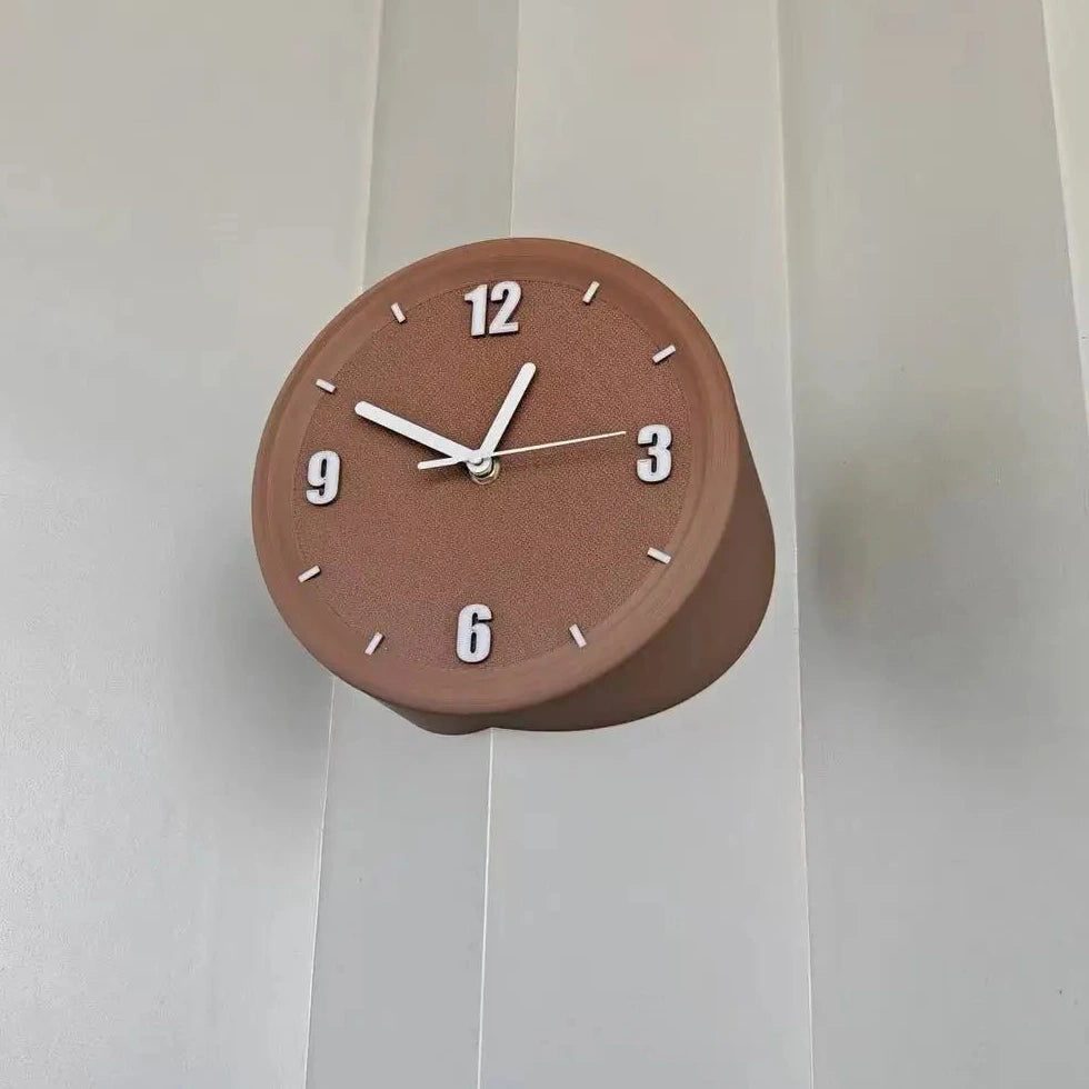 A round terracotta brown wall clock with white Arabic numerals and hands, mounted on a white paneled wall.