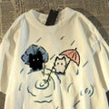 White T-shirt with cartoon cat cats design.