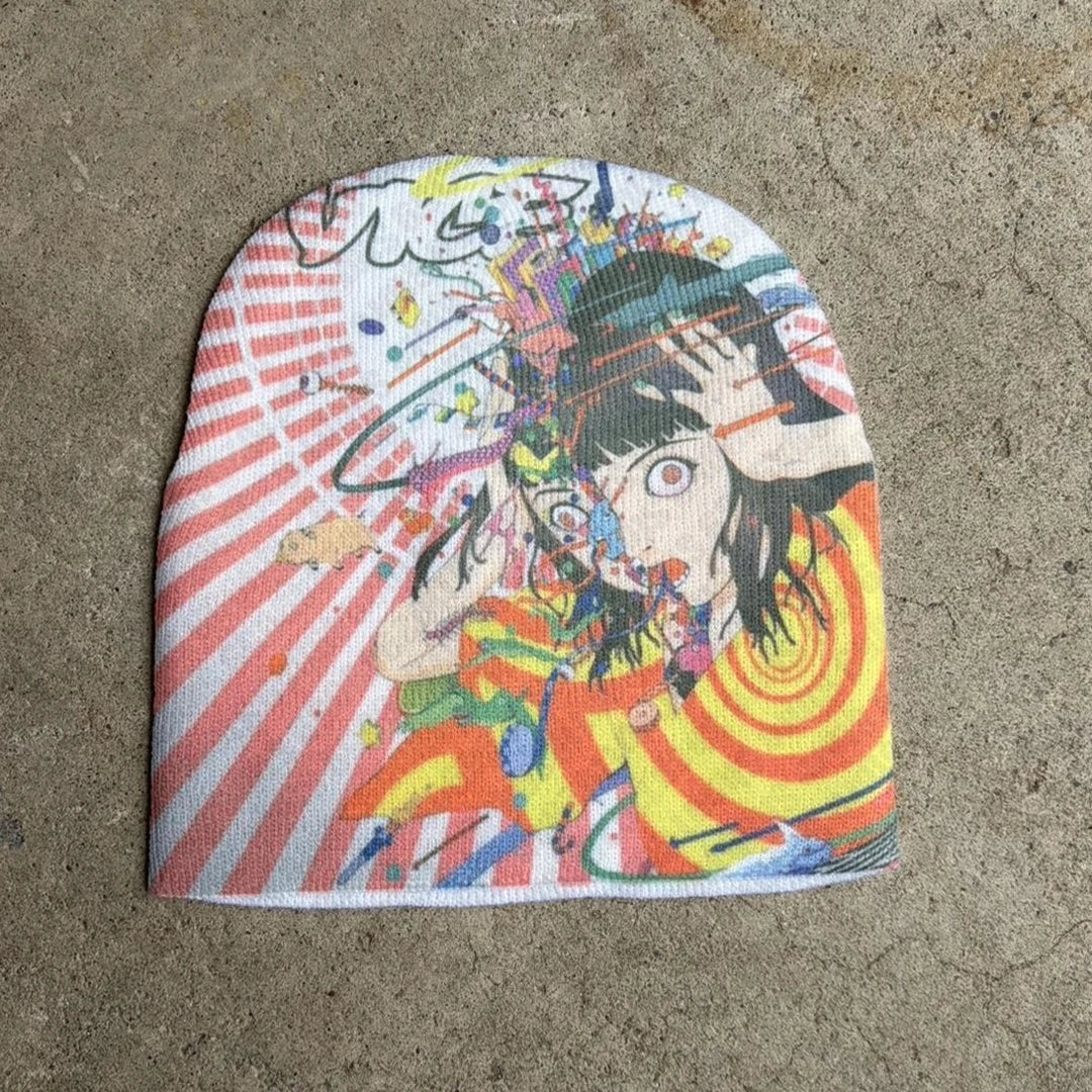 Colorful beanie with gothic anime-style design on a concrete surface