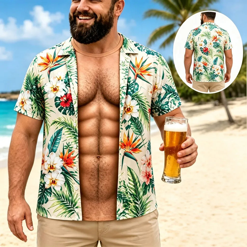 A man on a beach wearing a short-sleeve open button-up Hawaiian shirt with a tropical floral print. The shirt has green palm leaves and orange, red, and white flowers on a light beige background.