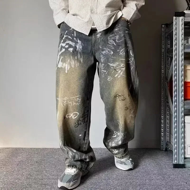 Person wearing graffiti-style jeans in an indoor setting