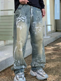 Person wearing light blue jeans with white paint splashes outdoors.