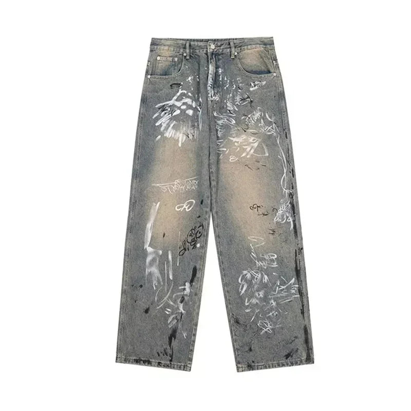 Distressed gray jeans with paint splatter design on a white background