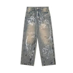 Distressed gray jeans with paint splatter design on a white background