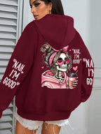Maroon hoodie with skeleton design and text on the back, worn by a person.