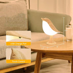 Bird-shaped lamp on a wooden table with USB charge port and touch control features highlighted.