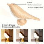 Wooden bird-shaped lamp with control options and color/dim settings.