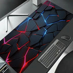 Gaming desk setup with a large geometric-patterned mouse pad, keyboard, and mouse.