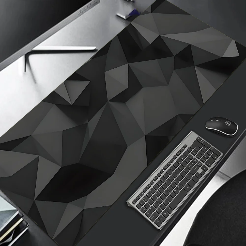 Desk setup with geometric-patterned desk pad, keyboard, mouse, and monitor.