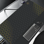 Large black desk mat with hexagonal pattern on a desk with keyboard and mouse.