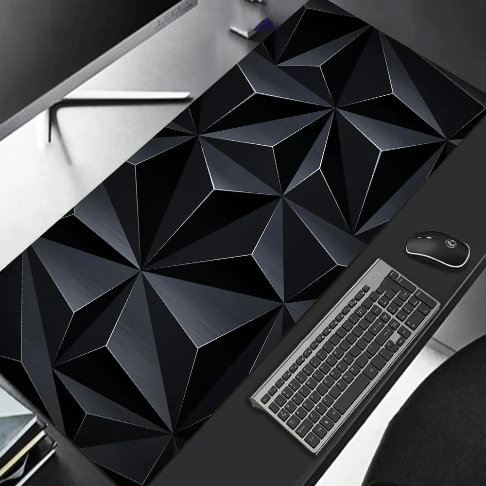 Geometric black desk mat on a desk with a keyboard and mouse.