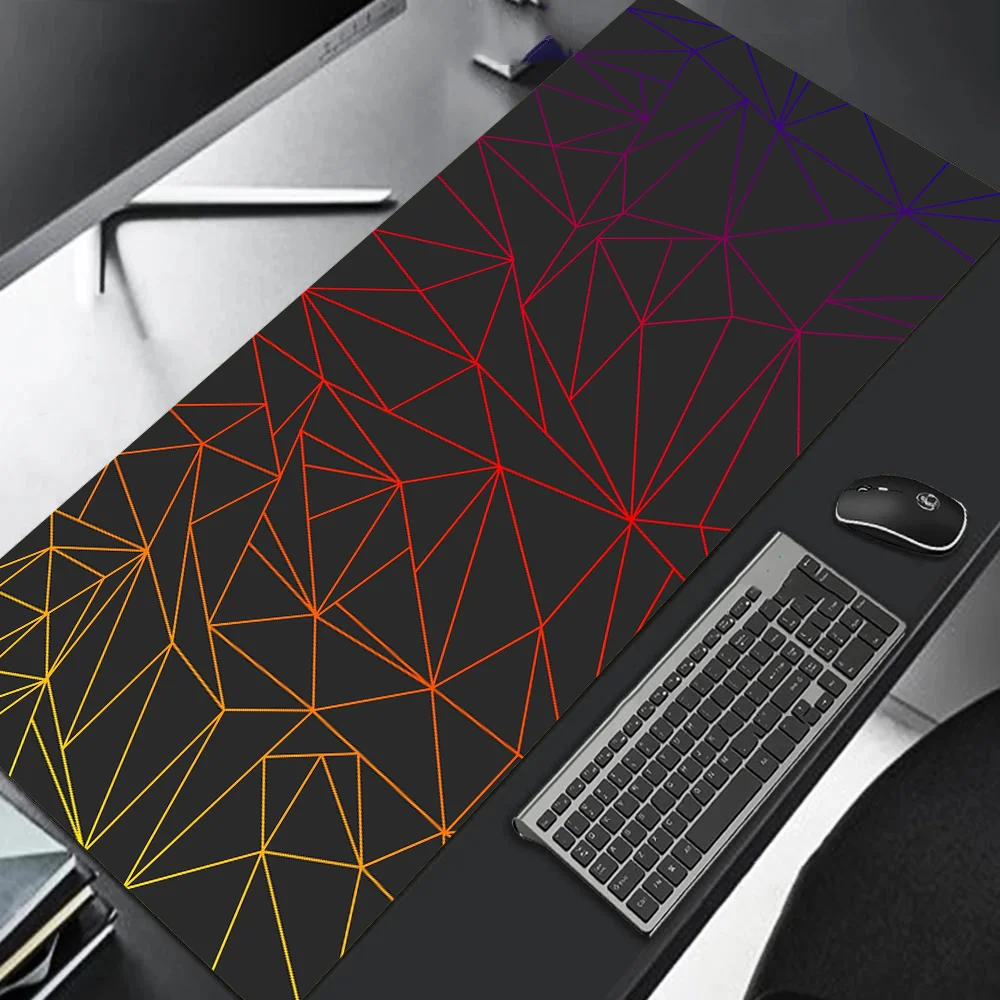 Geometric patterned desk mat with keyboard, mouse, and monitor on a desk.