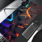 Colorful desk mat with geometric design on a desk with keyboard and mouse.