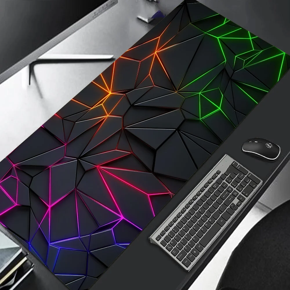 Gaming desk setup with a colorful geometric desk pad, keyboard, and mouse.