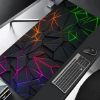 Gaming desk setup with a colorful geometric desk pad, keyboard, and mouse.