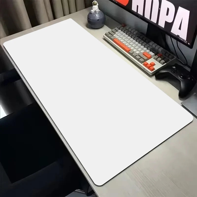 Desk setup with a large white desk mat, keyboard, mouse, and monitor.