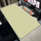 Desk setup with a large mouse pad, keyboard, and monitor on a desk.