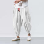 White pants with a red and black stripe on a white background