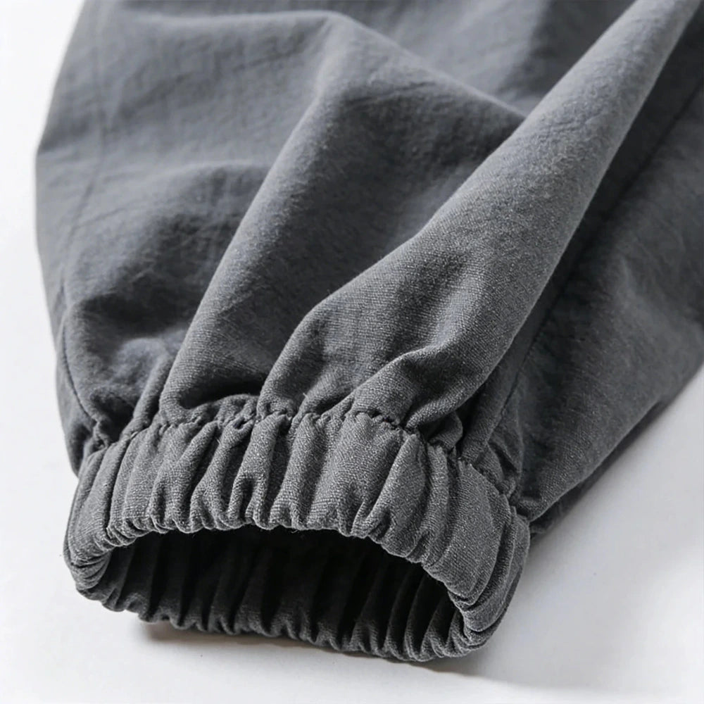 Close-up of gray pants with an elastic waistband on a white background