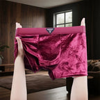 A pair of men's velvet briefs in a rich magenta-pink color.