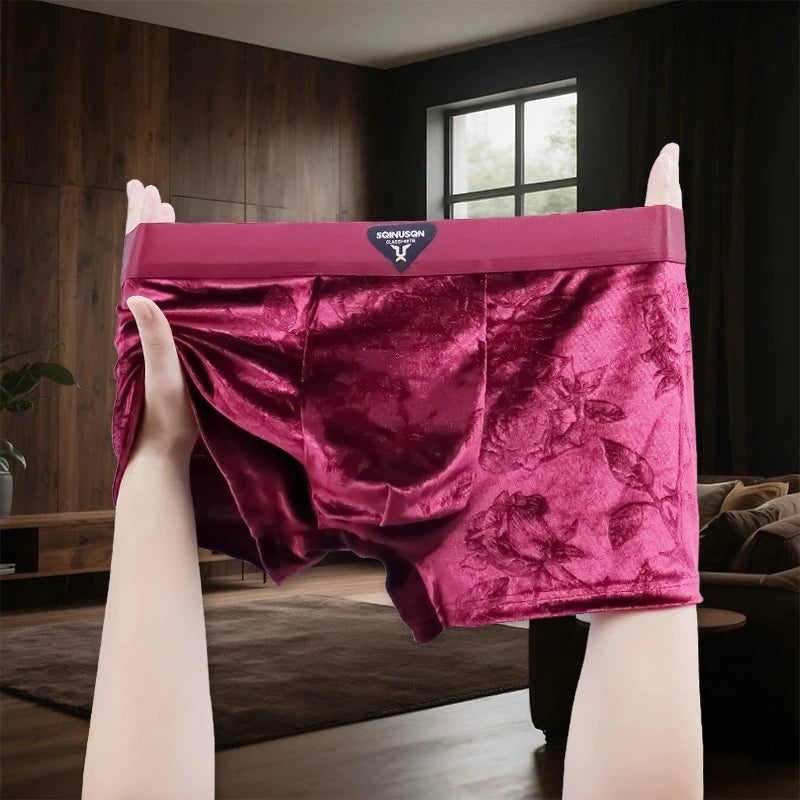 A pair of men's velvet briefs in a rich magenta-pink color.