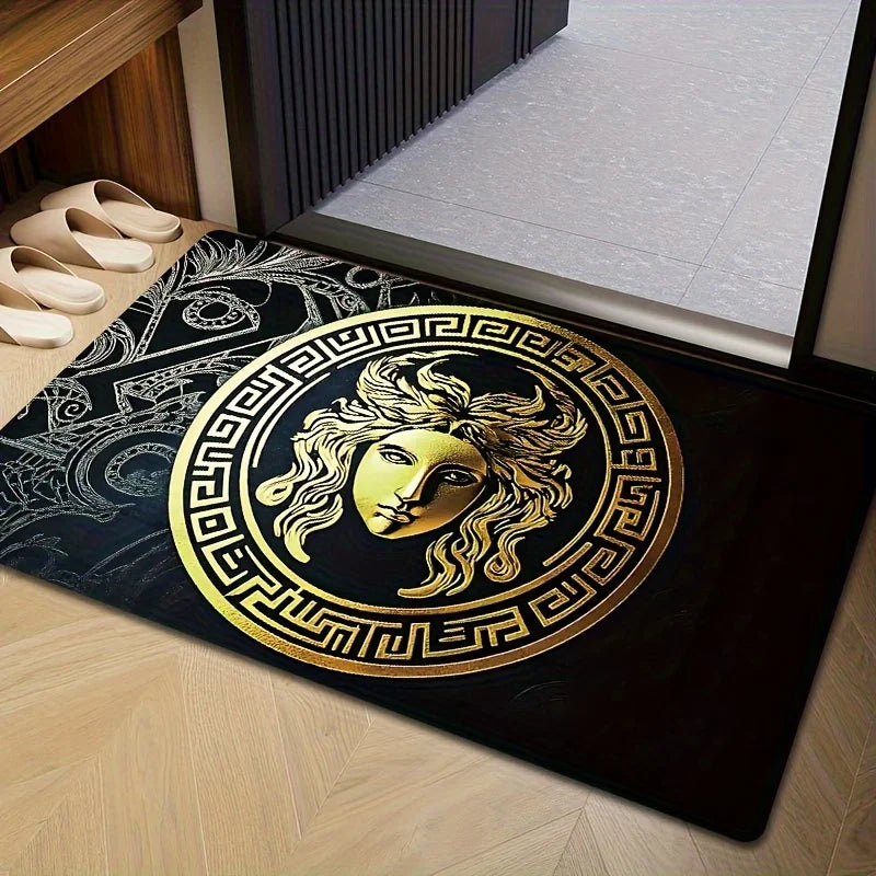 Decorative doormat with gold and black design on a wooden floor.