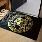 Decorative doormat with gold and black design on a wooden floor.