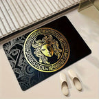 A mat with a large gold Medusa head emblem and Greek key border.