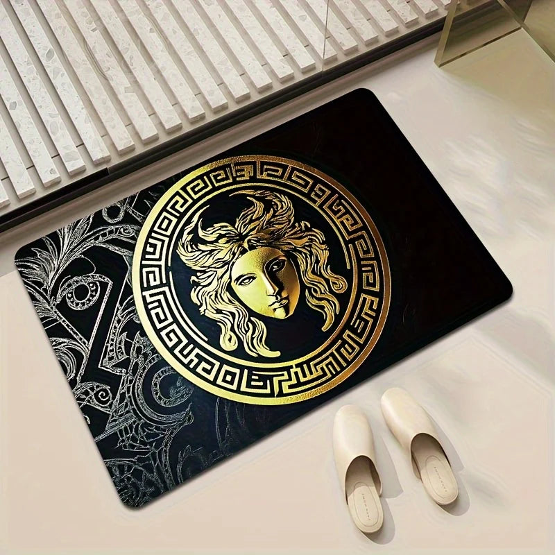 A mat with a large gold Medusa head emblem and Greek key border.