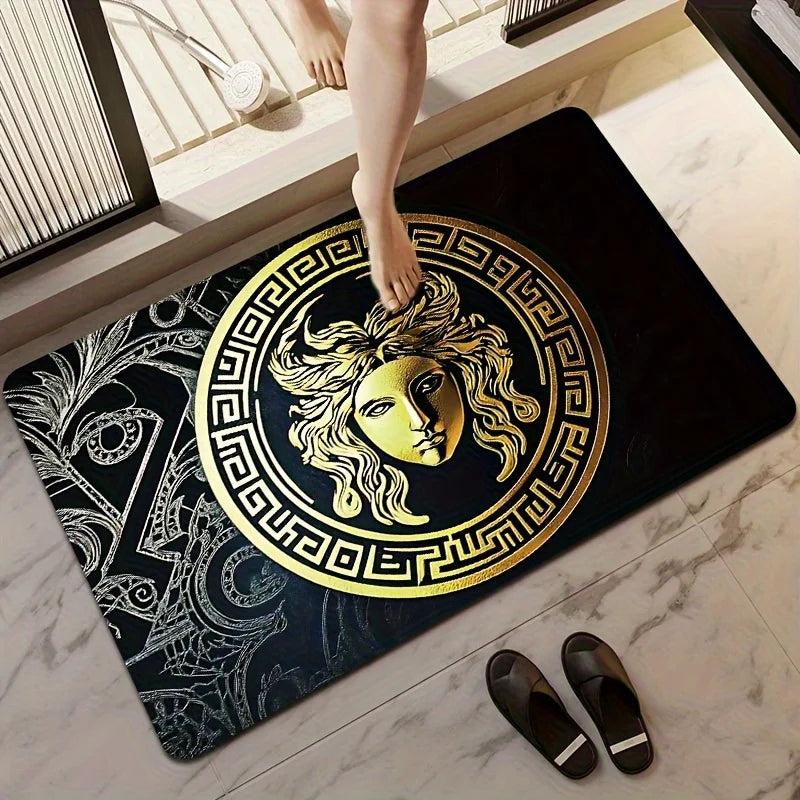 Decorative doormat with gold Medusa design on a marble floor.
