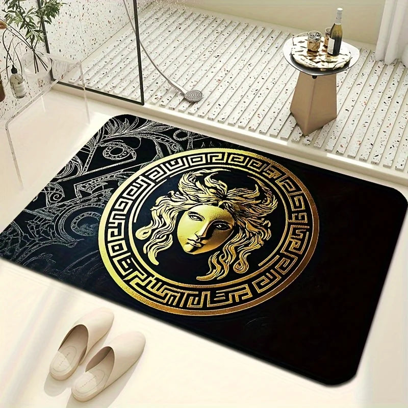 A bath mat with a large gold Medusa head emblem and Greek key border on a bathroom floor.