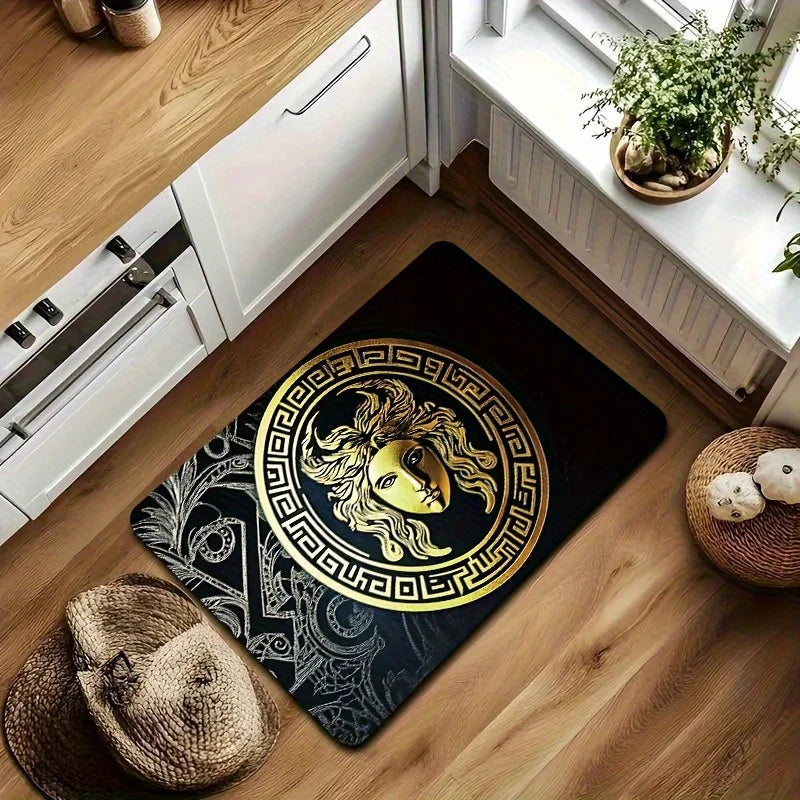 A floor mat with a large gold Medusa head motif and Greek key border.
