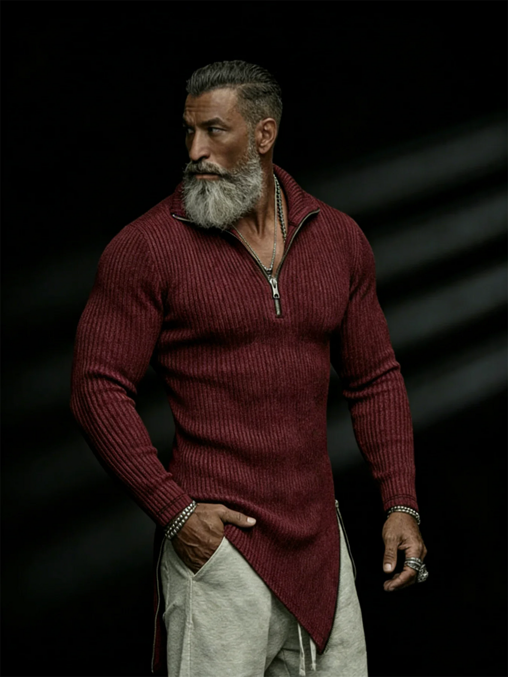 Man wearing a burgundy sweater with a dark background
