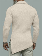 Man wearing a beige ribbed sweater against a gray background