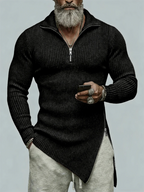 Man wearing a black sweater with a zipper, holding a phone, on a light gray background